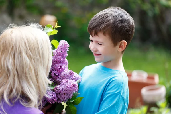 Little boy give flower to mom