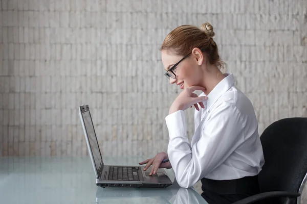Businesswoman searching online information on laptop