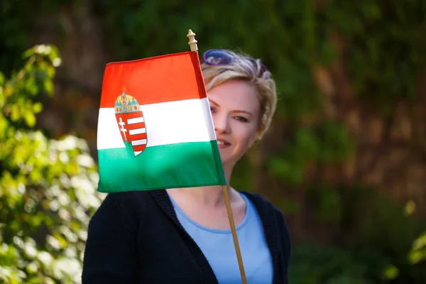 Blonde woman with Hungarian flag outdoor