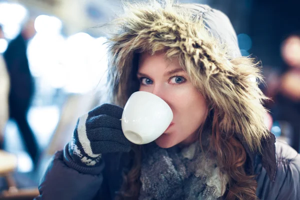 Woman drink hot tea outdoor at winter