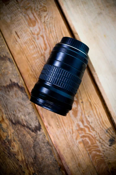 Profesialny lens on a wooden background