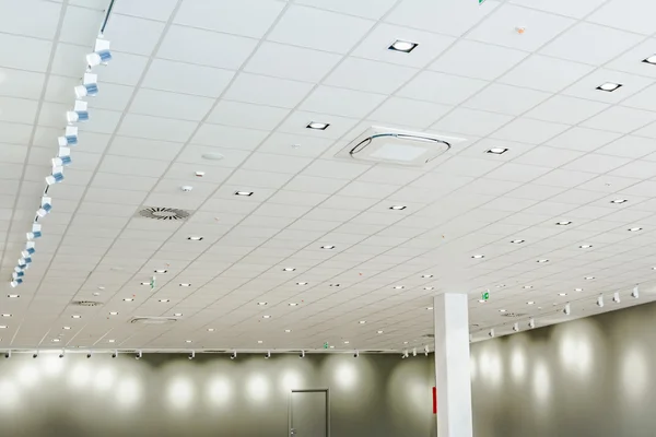 Modern office ceiling with air duct and lamps