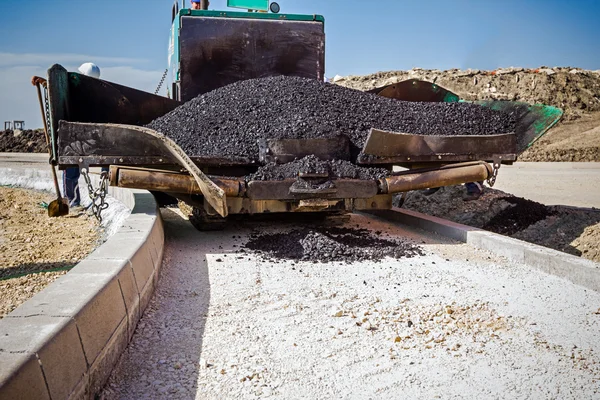 Tarmac road laying machine. Asphalt spreader