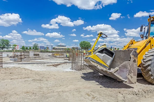 Excavator is moving over building site