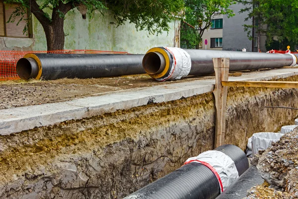 Newly laid pipe in a fresh trench. Unfinished pipeline