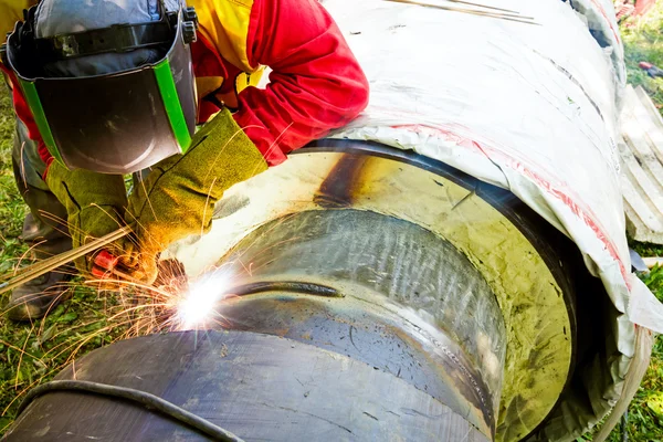 Close up shot welder until welding, sparks flying around.