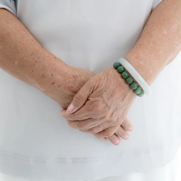 Aging process - old senior woman hands wrinkled skin