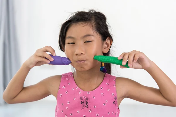 Asian child playing a chef at home