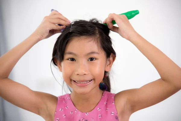 Asian child playing a chef at home