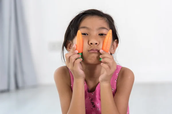 Asian child playing a chef at home