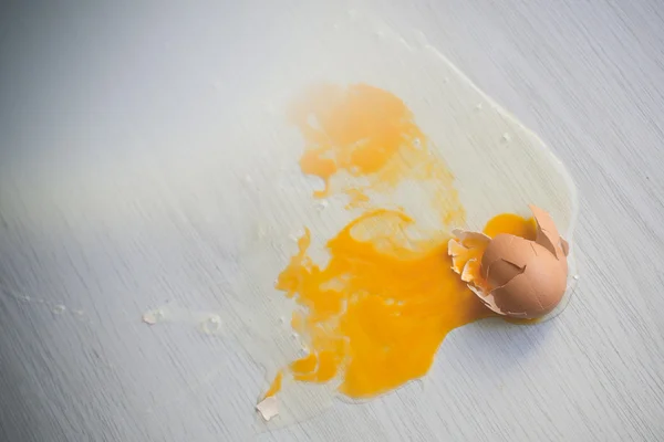 Broken egg on floor.