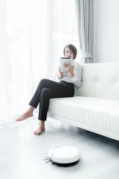 Modern life concept,  woman relaxing with tablet, automatic robo