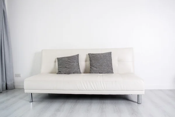 White leather sofa bed on white room, minimalist.
