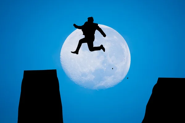 Silhouette Man Jumping in sun rise with big moon