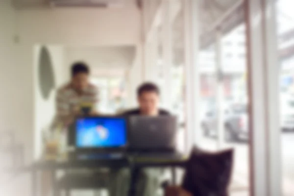 Blurry background men working in office.