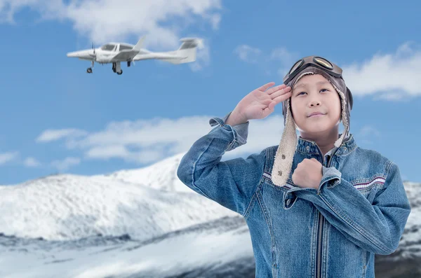 Asian pilot boy with Propeller plane with snow mountain and blue