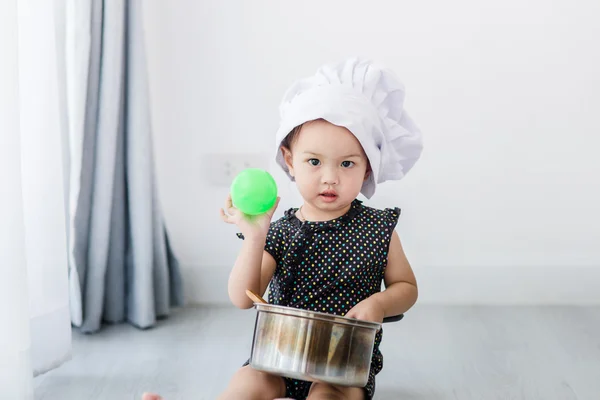 Asian child playing a chef
