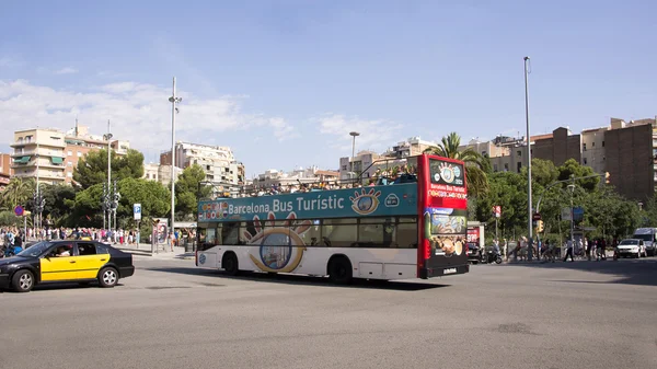Tourists visiting Barcelona on foot and with a tourist bus