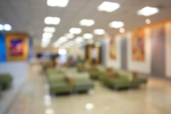 Blurred waiting chairs zone in hospital as background