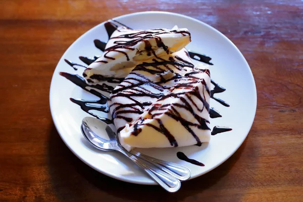 Traditional crepes with banana and chocolate cream