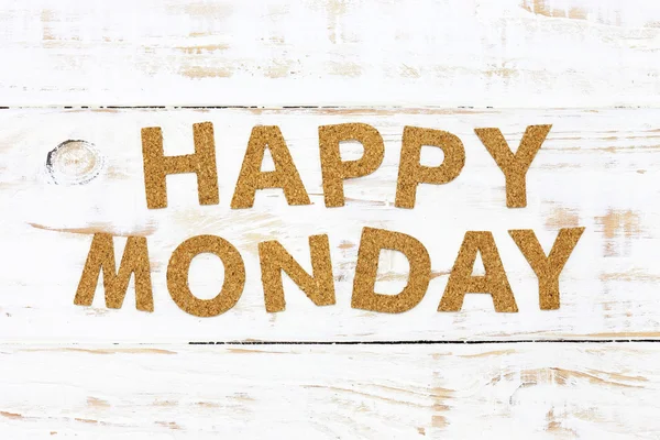 The word happy monday cork on white wood background