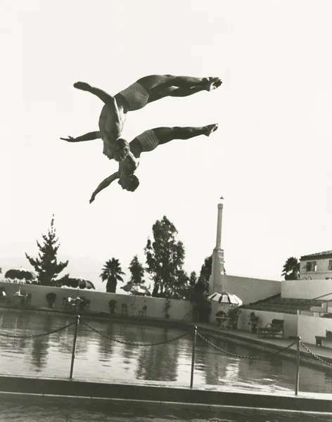 Synchronized divers in mid-air