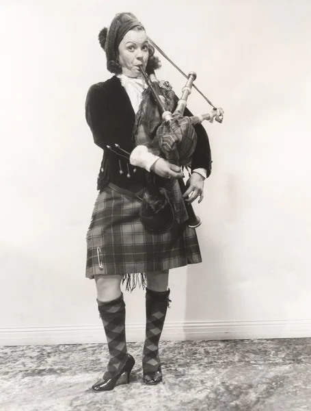 Young woman playing bagpipes