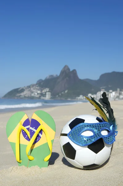 Carnival Mask Soccer Ball Football and Flip Flops on Beach Brazil