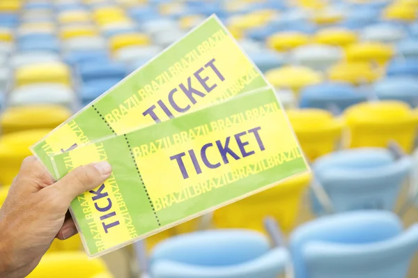 Sports Fan Holding Two Brazil Tickets at the Stadium