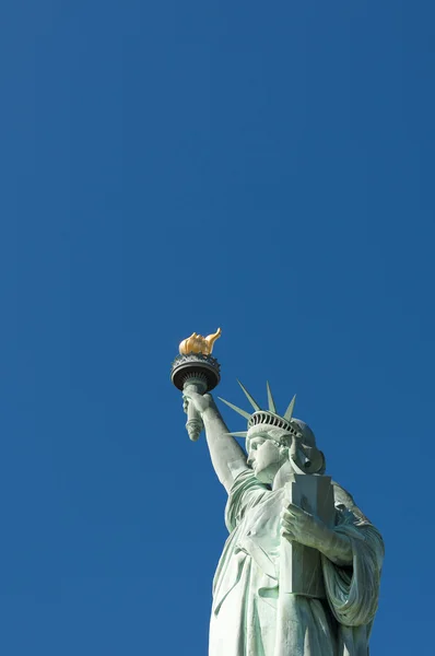 Portrait of the Statue of Liberty against Bright Blue Sky