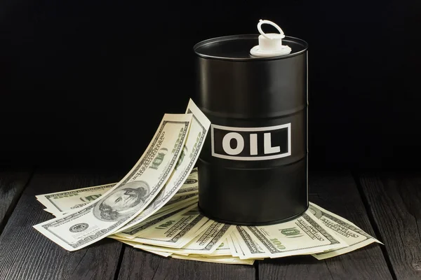 Oil business concept. Barrel of oil on dollar bills