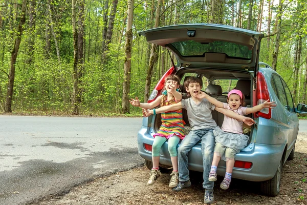 Three happy kids in car, family trip, summer vacation travel