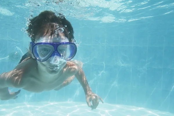 Young boy swimming under water in diving mask portrait