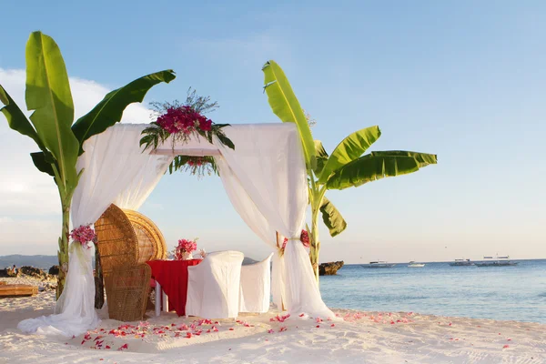 Wedding table and set up with flowers on tropical beach