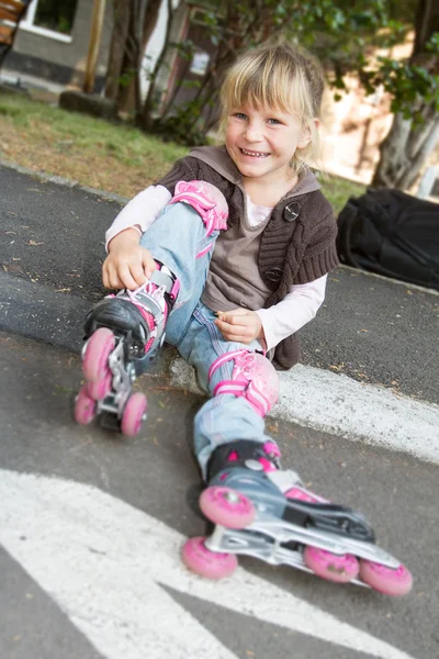 Cheerful roller skater - child girl - in protective equipment si