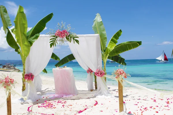 Wedding arch - tent - decorated with flowers on beach, tropical