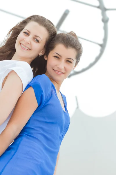 Two young happy women on natural background