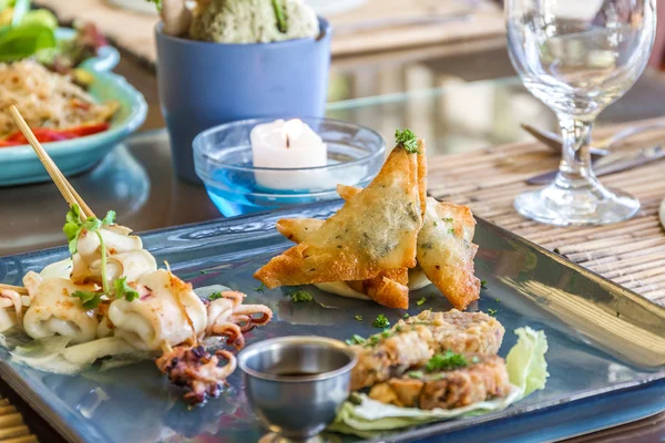 Seafood snacks, calamaris, squid rings served in outdoor restaur
