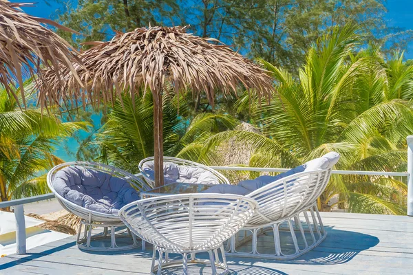 Lounge area on tropical beach background