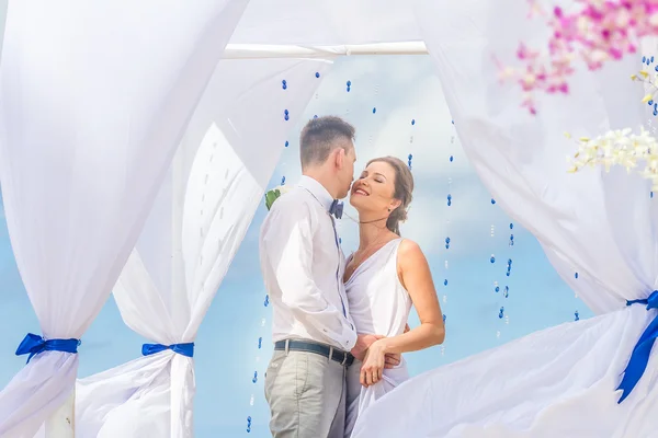 Bride and groom on their wedding day on natural tropical beach b