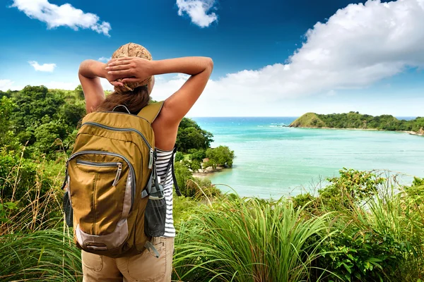 Tourist girl enjoying view of beautiful  hills and sea, travelin