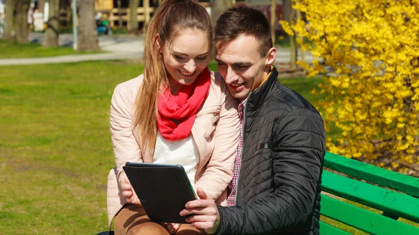 Couple with  tablet sitting