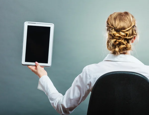 Woman sitting on chair with tablet