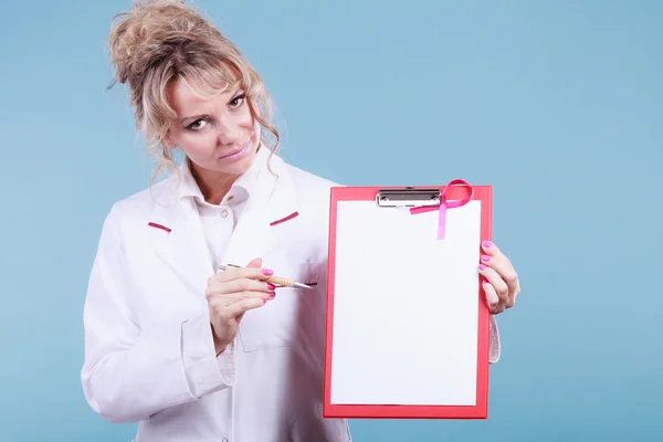 Doctor showing folder with pink ribbon by pen.
