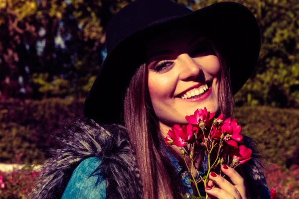 Girl with pink flowers smiling