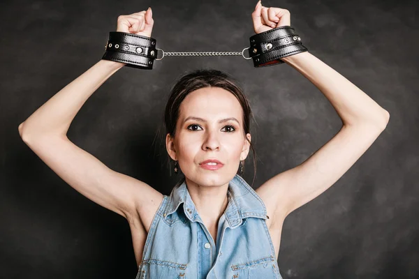 Arrest and jail. Criminal woman prisoner girl in handcuffs