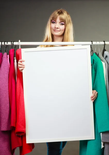 Woman in mall wardrobe with blank banner copyspace