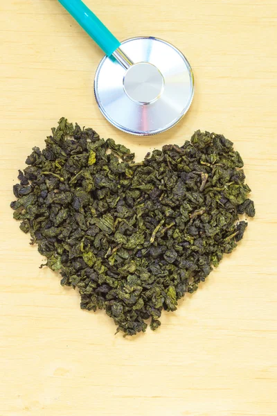 Green tea leaves and stethoscope