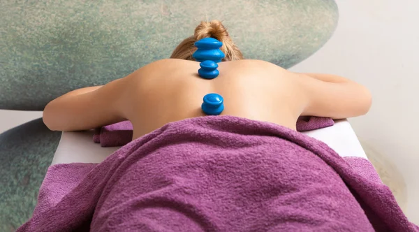 Woman having cupping-glass massage