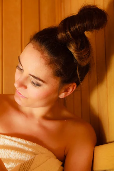 Woman relaxing in sauna room